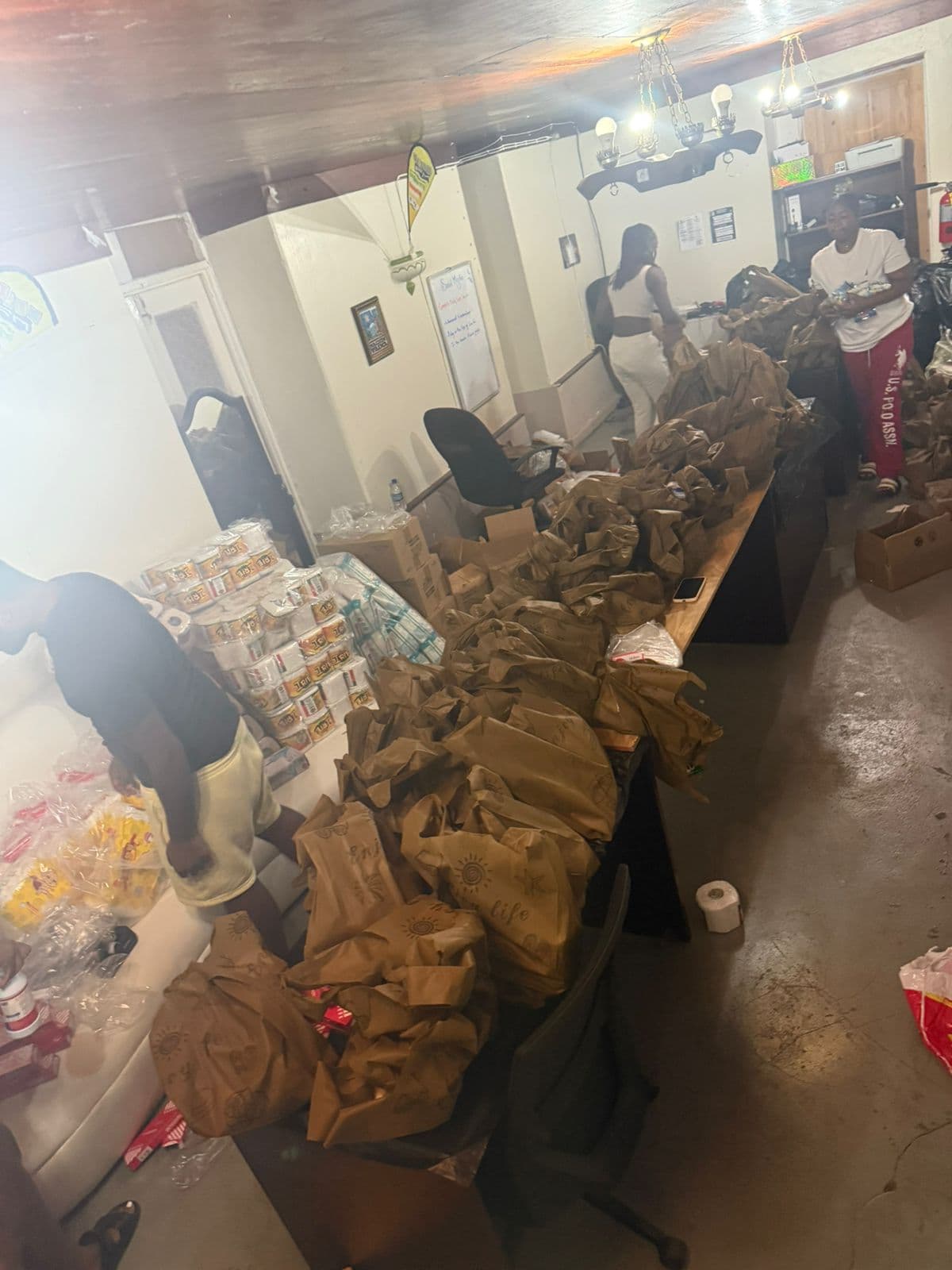 Volunteers assembling packages in the community hall